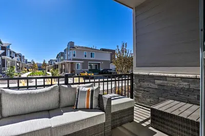 a couch on the balcony of a house at Near Hiking and Biking Trails Townhome with Patio in Aurora