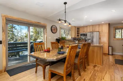 a kitchen and dining room with a table and chairs at 59 Jabberwocky Home by Stay Winter Park in Fraser