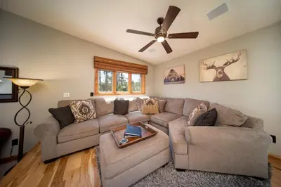 a living room with a couch and a ceiling fan at 59 Jabberwocky Home by Stay Winter Park in Fraser