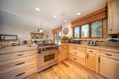 a kitchen with wooden cabinets and a stove at 59 Jabberwocky Home by Stay Winter Park in Fraser