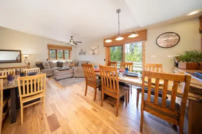 a dining room and living room with a table and chairs at 59 Jabberwocky Home by Stay Winter Park in Fraser