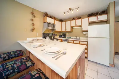 a kitchen with a large white island in a kitchen at Snowblaze Condos Building E unit 310 by Stay Winter Park in Winter Park