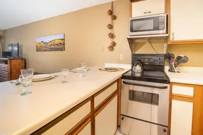 a kitchen with a stove and a microwave at Snowblaze Condos Building E unit 310 by Stay Winter Park in Winter Park