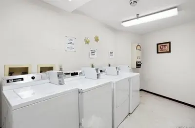 a white laboratory with white washers and sinks in a room at Snowblaze Condos Building E unit 310 by Stay Winter Park in Winter Park