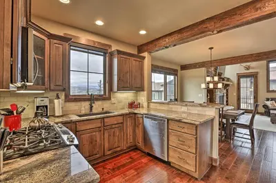 a kitchen with wooden cabinets and a counter top at Luxurious Fraser Townhome with Private Hot Tub! in Fraser