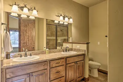 a bathroom with two sinks and a large mirror at Luxurious Fraser Townhome with Private Hot Tub! in Fraser