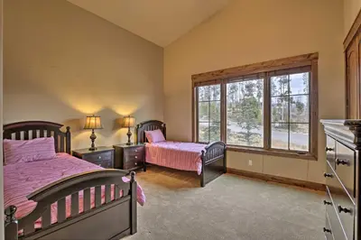 a bedroom with two beds and a window at Luxurious Fraser Townhome with Private Hot Tub! in Fraser