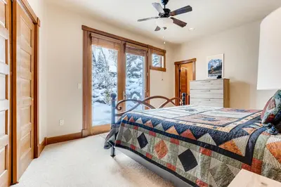 a bedroom with a bed and a window at Gray Moose in Breckenridge