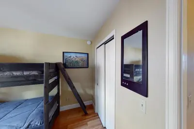 a bedroom with a bunk bed and a mirror at Quaint Mountain Condo in Frisco