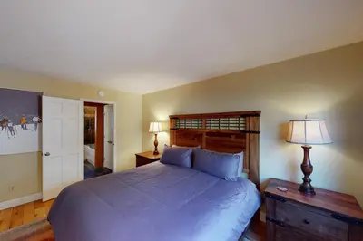 a bedroom with a large bed and a lamp at Quaint Mountain Condo in Frisco