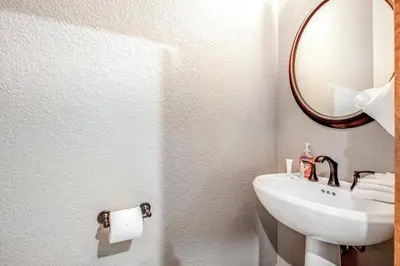 a bathroom with a sink and a mirror at Alpine Holidays Ski Tip in Keystone