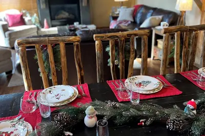 a table with plates and wine glasses on it at Alpine Holidays Ski Tip in Keystone