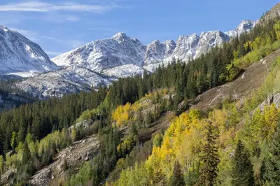 a mountain valley with trees and snow covered mountains at Alpine Holidays Ski Tip in Keystone