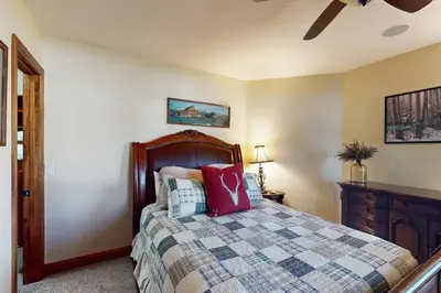 a bedroom with a bed with a checkered blanket at Moose Whiskers in Keystone