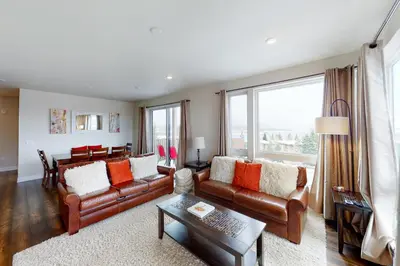a living room with brown leather couches and a table at La Bonte Townhomes Unit 304 in Dillon