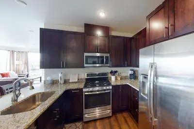 a kitchen with wooden cabinets and stainless steel appliances at La Bonte Townhomes Unit 304 in Dillon