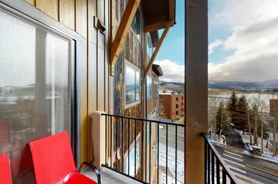 a balcony with a red chair and a view at La Bonte Townhomes Unit 304 in Dillon
