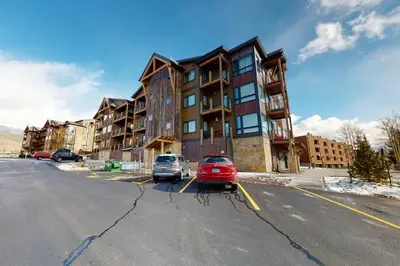 two cars parked in a parking lot in front of a building at La Bonte Townhomes Unit 304 in Dillon