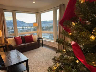 a christmas tree in a living room with a view at La Bonte Townhomes Unit 304 in Dillon