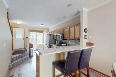 a kitchen with a counter and two bar stools at Saddle Ridge Townhome 402 in Silverthorne