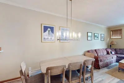 a living room with a table and a couch at Saddle Ridge Townhome 402 in Silverthorne
