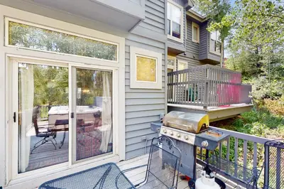 a patio with a grill and a table at Saddle Ridge Townhome 402 in Silverthorne