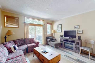 a living room with a couch and a tv at Saddle Ridge Townhome 402 in Silverthorne