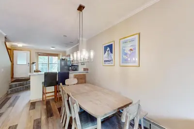 a dining room and kitchen with a table and chairs at Saddle Ridge Townhome 402 in Silverthorne