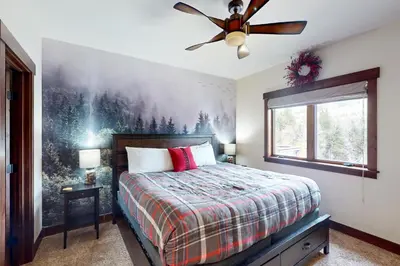 a bedroom with a bed and a ceiling fan at Blue River Condo Unit 203 in Silverthorne
