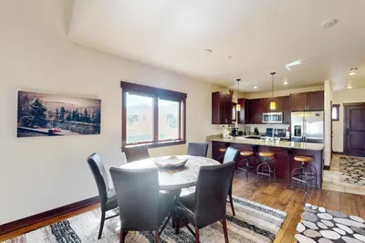 a kitchen and dining room with a table and chairs at Blue River Condo Unit 203 in Silverthorne