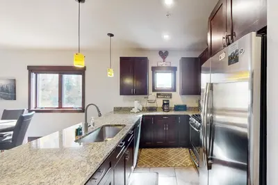a kitchen with a sink and a refrigerator at Blue River Condo Unit 203 in Silverthorne