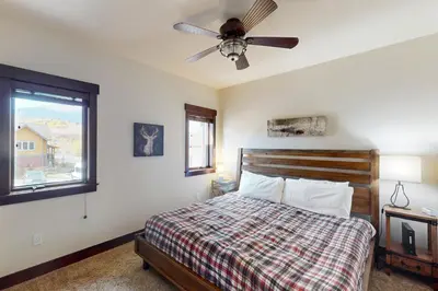 a bedroom with a bed and a ceiling fan at Blue River Condo Unit 203 in Silverthorne