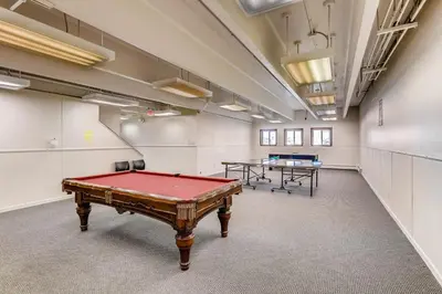 a ping pong table in a room with two tables at Mountian View Condo Unit S303 in Dillon