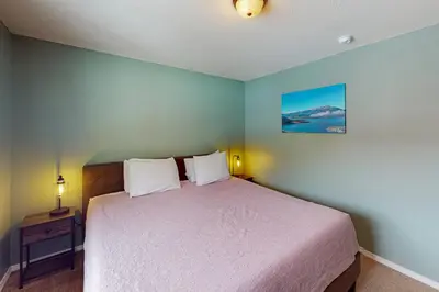 a bedroom with a large bed with two pillows at Mountian View Condo Unit S303 in Dillon