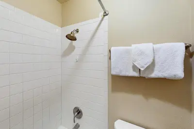 a bathroom with a toilet and a shower with towels at Mountian View Condo Unit S303 in Dillon
