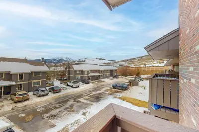 a view from the balcony of a apartment complex with snow at Mountian View Condo Unit S303 in Dillon