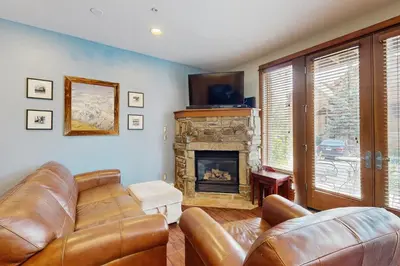 a living room with a couch and a fireplace at Hop Inn At Antlers Gulch in Keystone