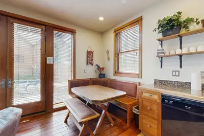 a kitchen with a wooden table and a dining room at Hop Inn At Antlers Gulch in Keystone