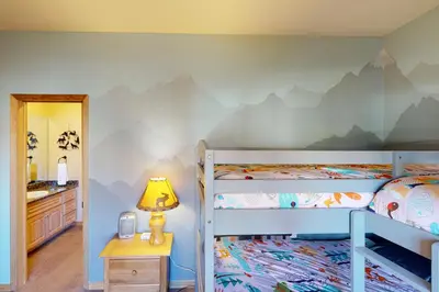 a bedroom with two bunk beds with a mountain mural on the wall at Teller Townhomes 106 in Frisco