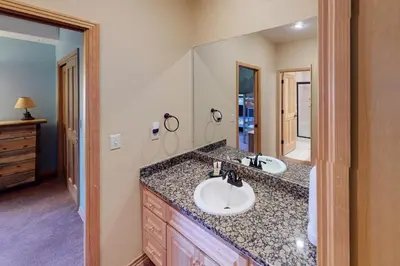 a bathroom with two sinks and a large mirror at Teller Townhomes 106 in Frisco