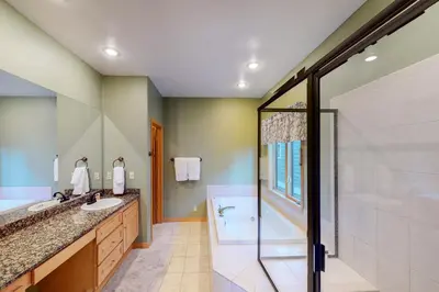 a bathroom with a shower and a sink and a tub at Teller Townhomes 106 in Frisco