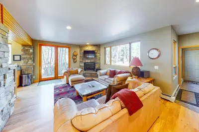 a living room with couches and a fireplace at Western Wild Flower in Frisco