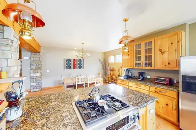 a kitchen with a stove and a counter top at Western Wild Flower in Frisco
