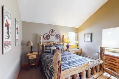 a bedroom with a bed with a wooden bed frame at Western Wild Flower in Frisco