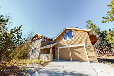 a house with a garage on a driveway at Western Wild Flower in Frisco