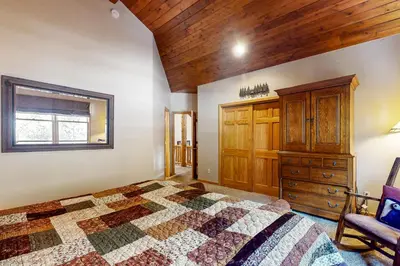 a bedroom with a bed and a wooden ceiling at Northstar Townhome Unit 1968 in Keystone