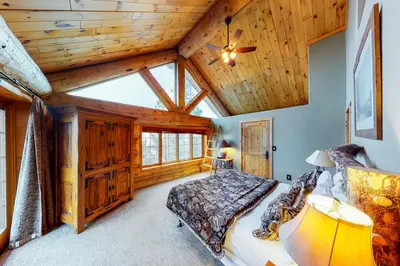 a bedroom with a bed and a wooden ceiling at Fairy Tale House in Dillon