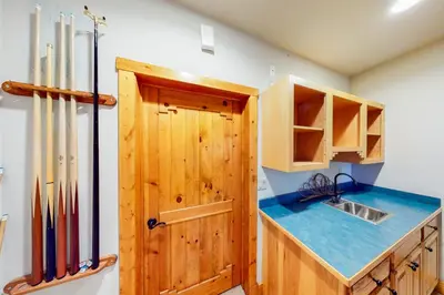 a kitchen with wooden cabinets and a blue counter top at Fairy Tale House in Dillon