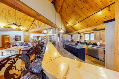 a large kitchen with a long wooden table in a cabin at Fairy Tale House in Dillon
