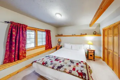 a bedroom with a bed and a window at Fairy Tale House in Dillon